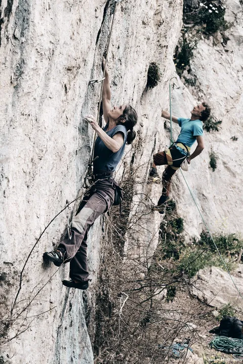 Grimpeuse sur une paroi calcaire striée du Vercors
